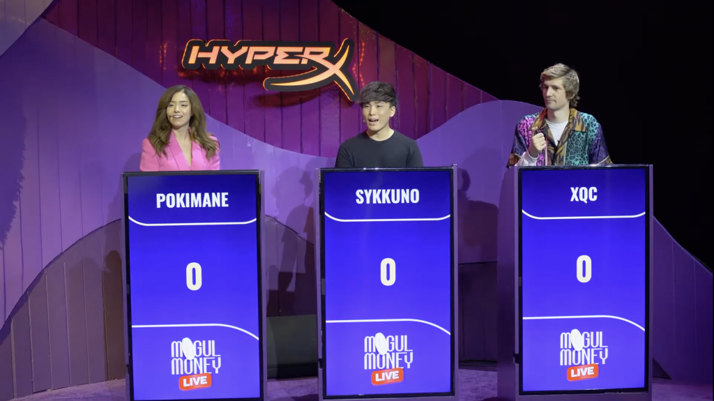Pokimane, Sykkuno, and xQc on stage at Mogul Money Live with Jeopardy-like podiums and the HyperX Gaming logo in the background in front of a purple curtain.